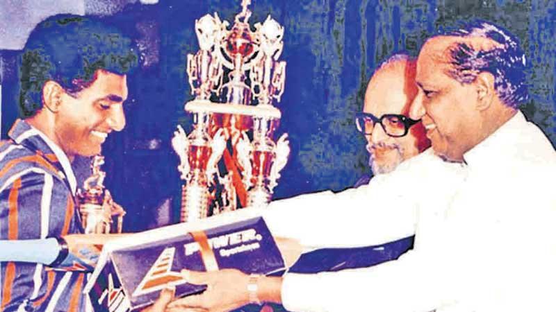 Muttiah Muralidaran received the Observer Schoolboy Cricketer of the Year in 1991 from then Housing and Construction Minister B. Sirisena Cooray in the presence of Editor-in-Chief H.L.D. Mahindapala