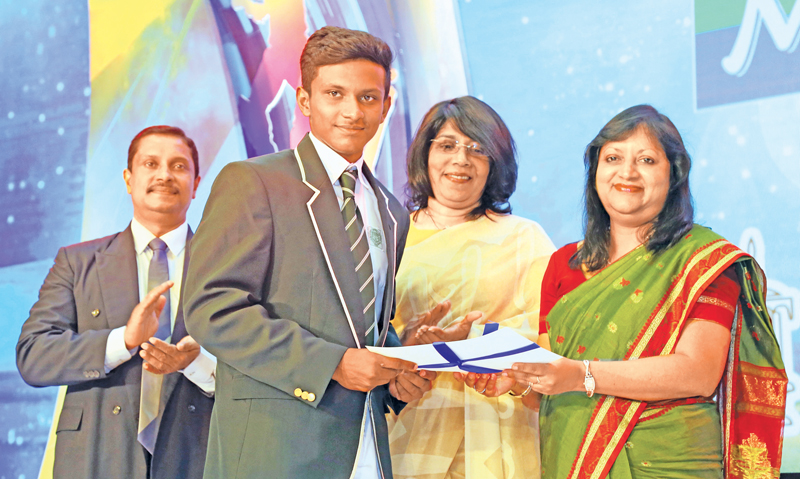 Sanjula Abeywickrama of Isipathana College the runner-up of the Most Popular Schoolboy Cricketer voting contest being presented with his Certificate by Secretary ANCL Kumudu Gunawardene  