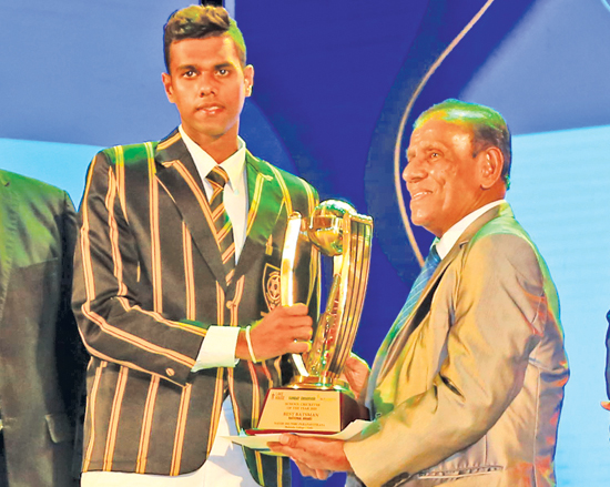 Best batsman Navod Paranavithana of Mahinda College accepts his award from ANCL Chairman, President’s Counsel W. Dayaratne