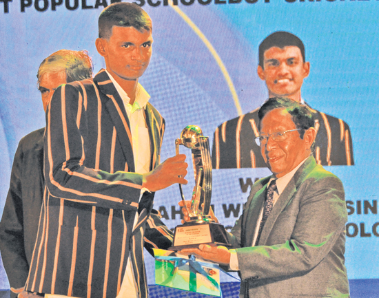Most Popular Schoolboy Cricketer of the Year 2020 runner up Ahan Wickramasinghe of Royal College receives his trophy from Senior Associate Editor, Sunday Observer Dudley Jansz