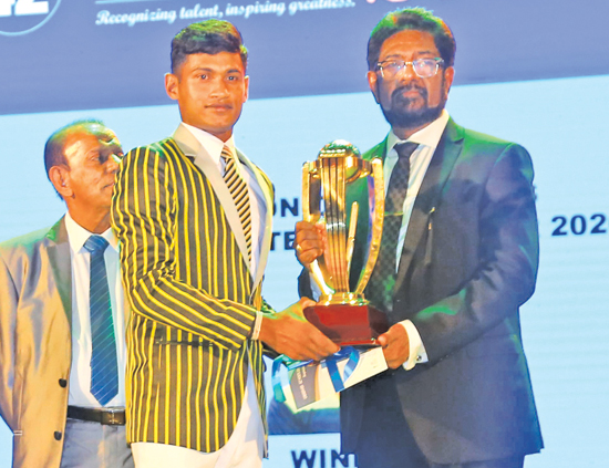 Division One Schoolboy Cricketer of the Year 2020 Pawan Ratnayake receives his award from Media and Information Minister Keheliya Rambukwella