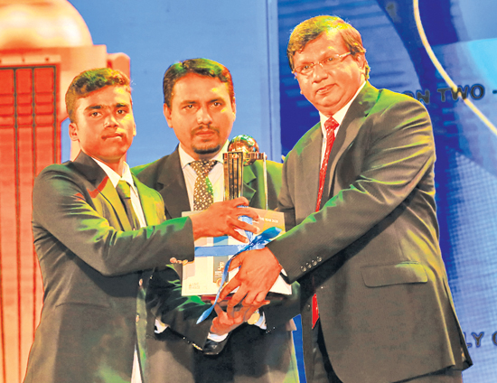 Best  Wicket Keeper Division Two Bashitha Perera of Holy Cross College, Kalutara is presented with his award by Deputy General Manager, Establishment ANCL Narada Sumanaratne with DGM Sales Nath Adikri