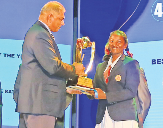 Captain of the Best Schoolgirl Team of the Year 2020 receives the award from Chairman of SLT Mobitel Rohan Fernando