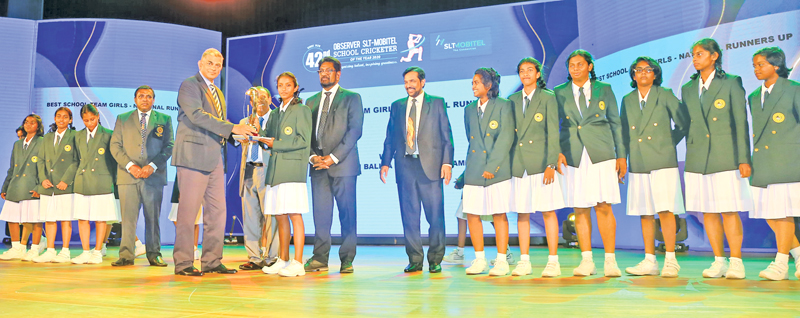 Best schoolgirl team runners-up Ratnaveli Balika Vidyalaya Gampaha get their award from SLT Mobitel Group Chairman Rohan Fernando in the presence of Media and Information Minister Keheliya Rambukwella, Ministry Secretary Jagath P Wijeweera, ANCL Chairman W Dayaratne PC and the Editor in Chief of the Sunday Observer Dinesh Weerawansa