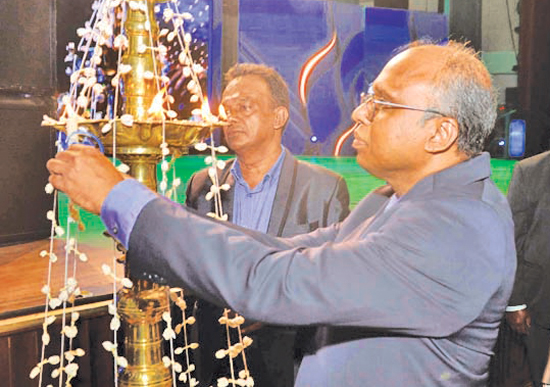 Lighting of the traditional oil lamp by  Director Operations, Canishka Witharana