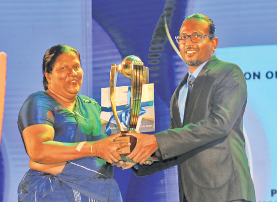 Best Batsman - Division one - winner Pawan  Ratnayake - Mahanama College Colombo. His mother receives the Award on behalf of him from official statistician Batsman.com CEO Kumara Gamhewage
