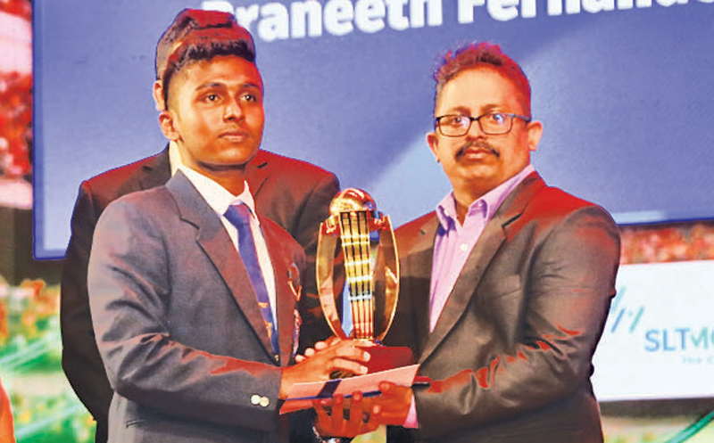 Division Three: Best Fielder Pranneeth Fernando of Basilica College Ragama being presented with the trophy by DGM Corporate Affairs Chandadana Bandara