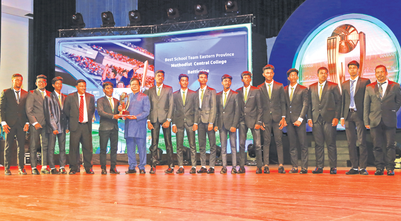 Best School Cricket team of the Year from Eastern Province Methodist Central College Batticaloa skipper receiving the award from Guest of Honor Minister of Transport and Highways and Mass Media Dr. Bandula Gunewardena