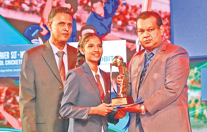 Girls Best Bowler  - Sapna Madhubashini from Devapathiraja College Rathgama is seen receiving the coveted Trophy from Daily News Editor in Chief Jayantha Sri Nissanka, Also in the picture is Uditha Kumarasinghe News Editor Sunday Observer