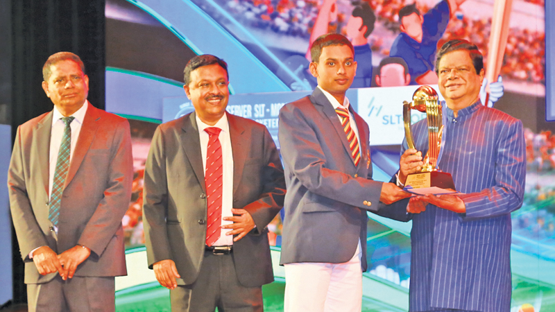 Division One Best Bowler - Tier B -  Nipun K. Premaratne of Thurstan College, Colombo being awarded the Trophy by Guest of Honour Minister of Transport & Highways and Mass Media Dr. Bandula Gunewardena. Also in the picture are Secretary to the Ministry of Mass Media and Chairman and Managing Director ANCL Anusha Palpita and Additional General Manager of ANCL Virajith Bois